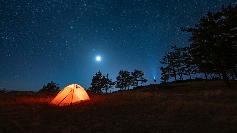 Lit-up camping tent under the stars