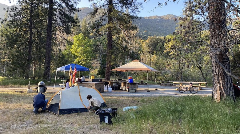 A man and a child set up a tent at one of the Miller Canyon Group campsites