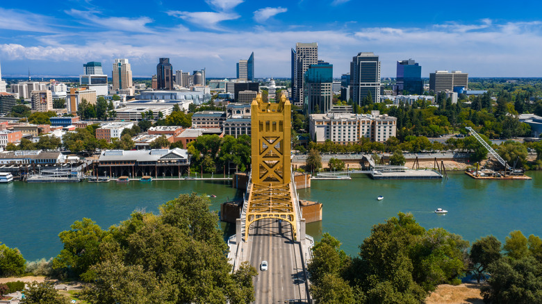 Golden Tower Bridge over the Sacramento River with city skyline