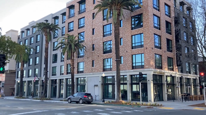 Exterior of modern Fort Sutter Hotel Sacramento building with palm trees