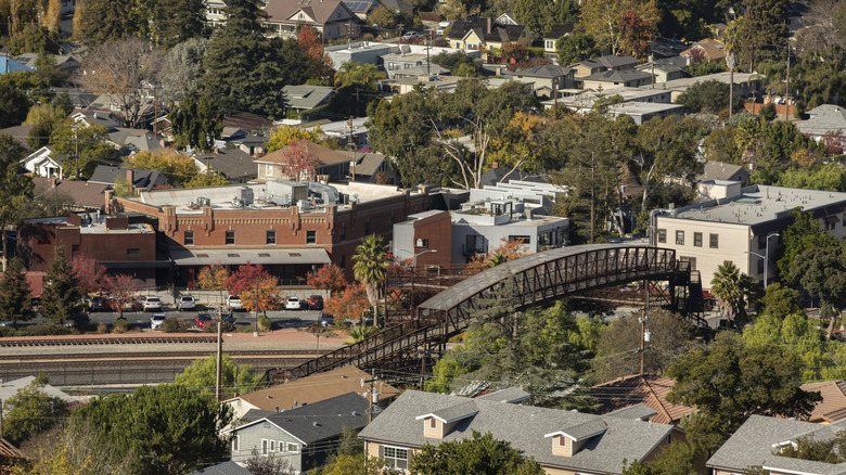 Aerial view of San Luis Obispo showing buildings surrounding train tracks and a bridge