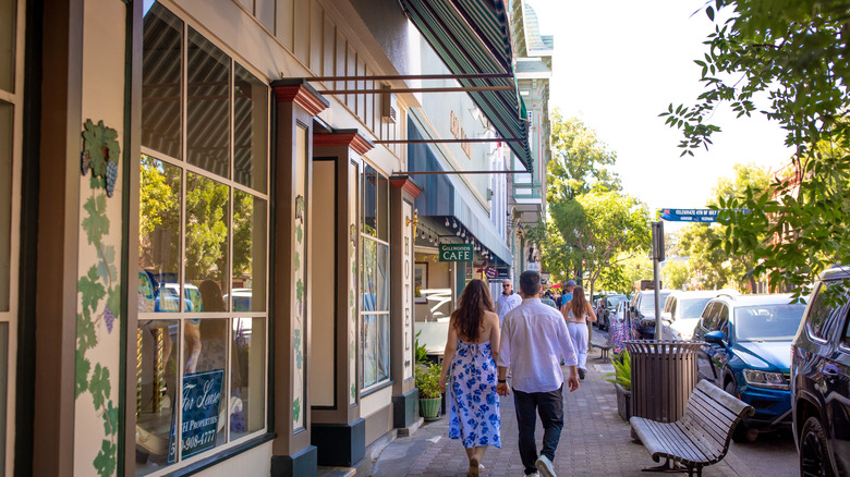 View of a couple walking down a shopping street in St. Helena, California