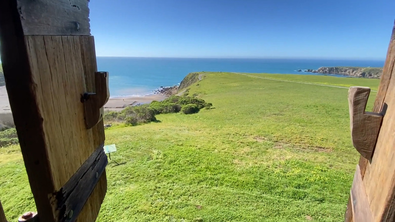 A peek-a-boo window shot of the Pacific Ocean from a Fort Ross structure