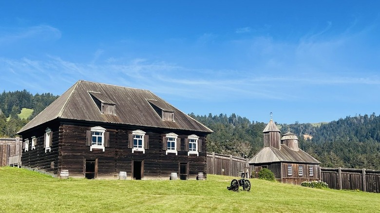 A canon in front of the chapel and former home of the fort's founder at Fort Ross State Historical Park in California