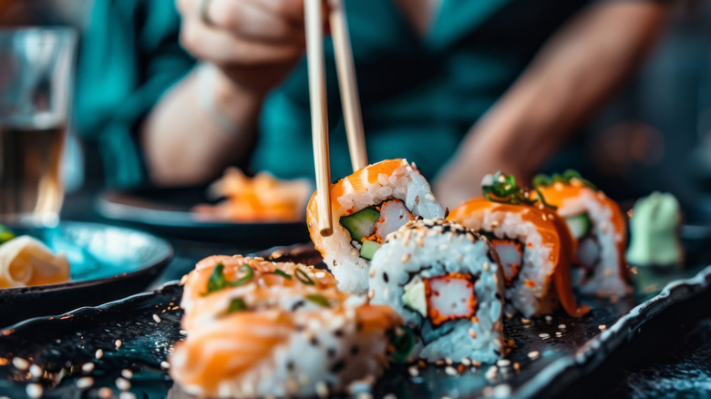 Eating sushi with chopsticks