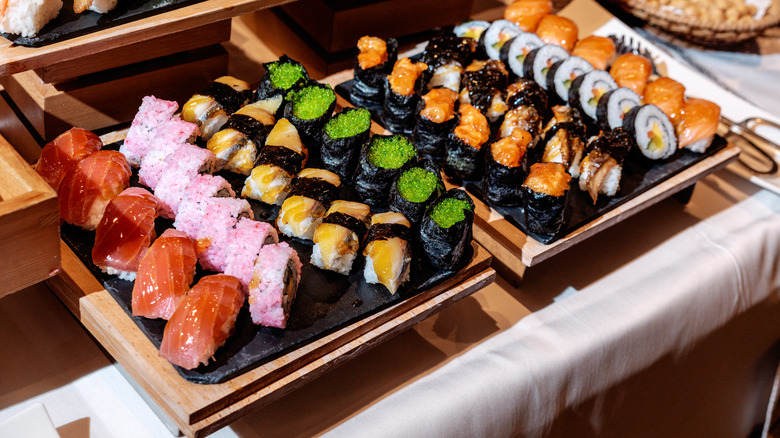 Rows of sushi on wooden boards