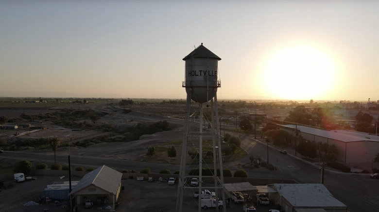 Sunset over town with water tower in view over buildings