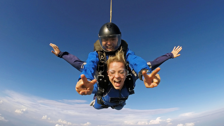 Woman skydiving with an instructor mid-air