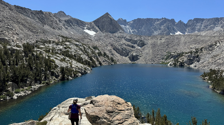 A woman looks over Upper Lamarck Lake in California.