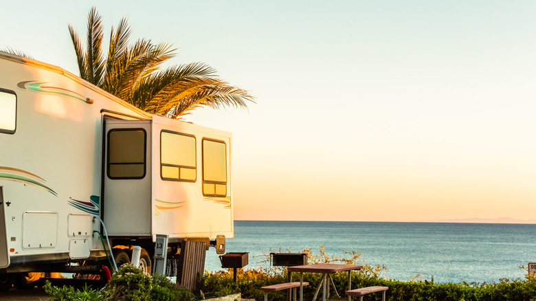 An RV and a picnic table near the beach
