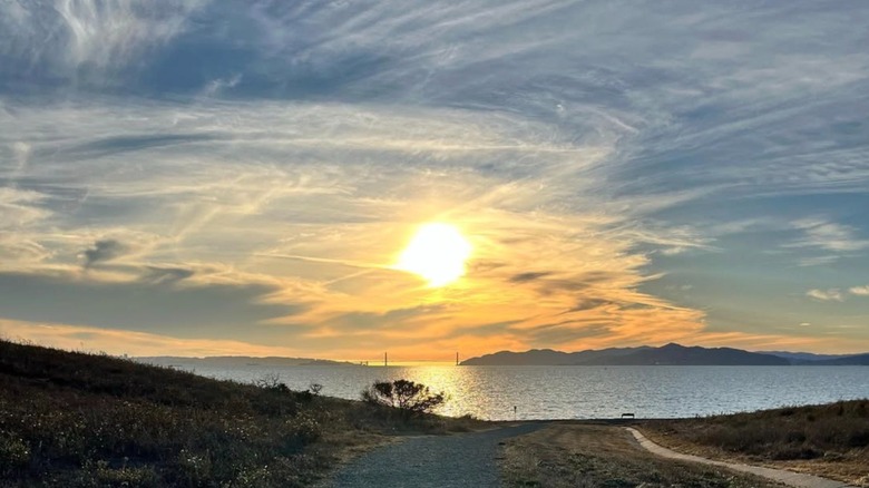 The sun sets over the bay at Cesar Chavez Park