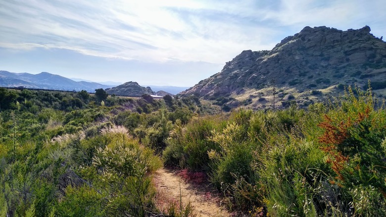 Footpaths amid hills covered in greenery at Corriganville Park in Southern California