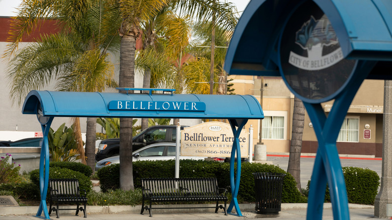 A public transit stop with benches and shade in Bellflower