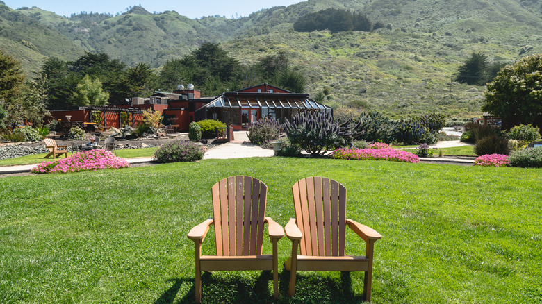 Two Adirondack chairs on the lawn at Ragged Point Inn & Resort