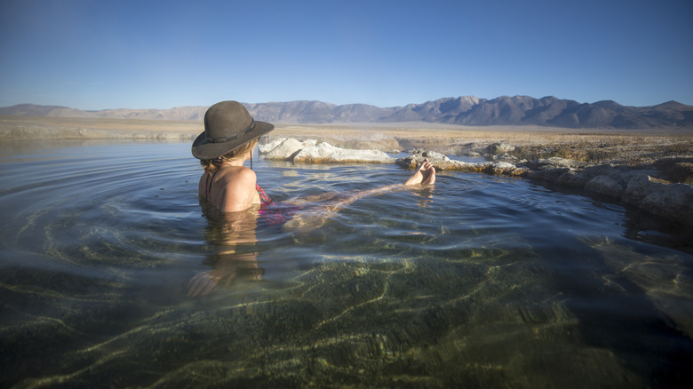 Person soaking in hot springs