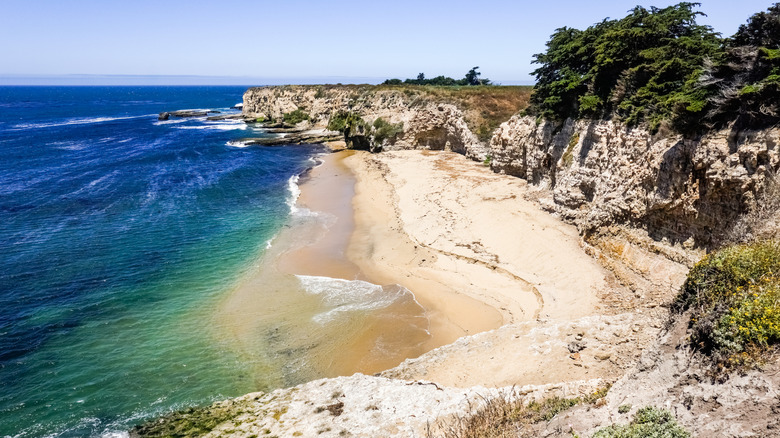 Aquamarine waves crash on the beach at Wilder Ranch State Park, in Santa Cruz, California
