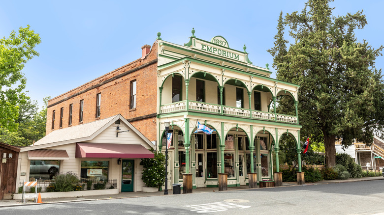 1897 Emporium green and white historic facade on sunny day Jamestown CA