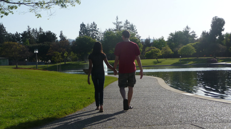 A couple walks by a pond in Sunnyvale, California