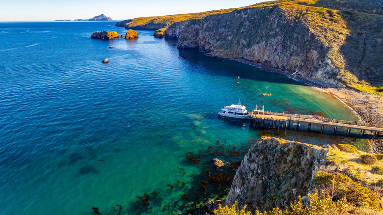 View of ocean with a boat, and surrounding cliffs at Santa Cruz Island