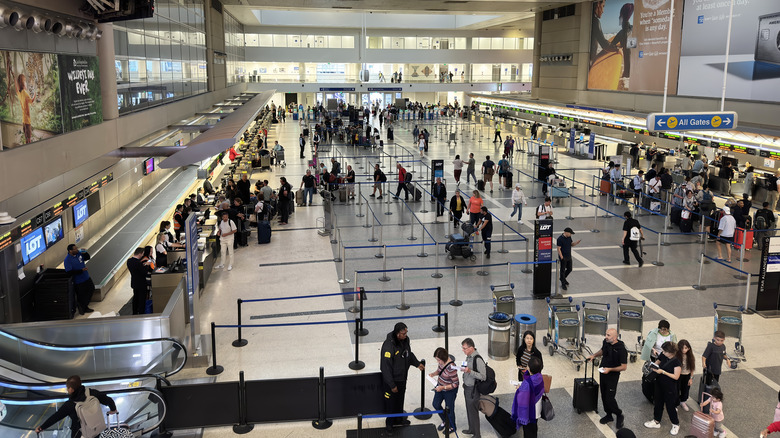 People waiting in lines inside LAX