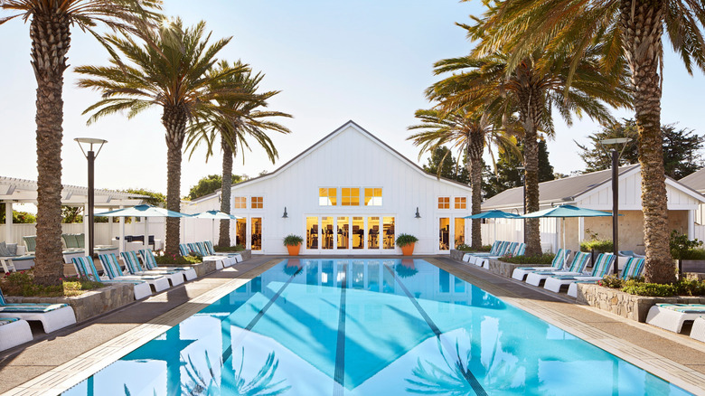 Pool and club house surrounded by palms and lounge chairs at Carneros Resort and Spa, California
