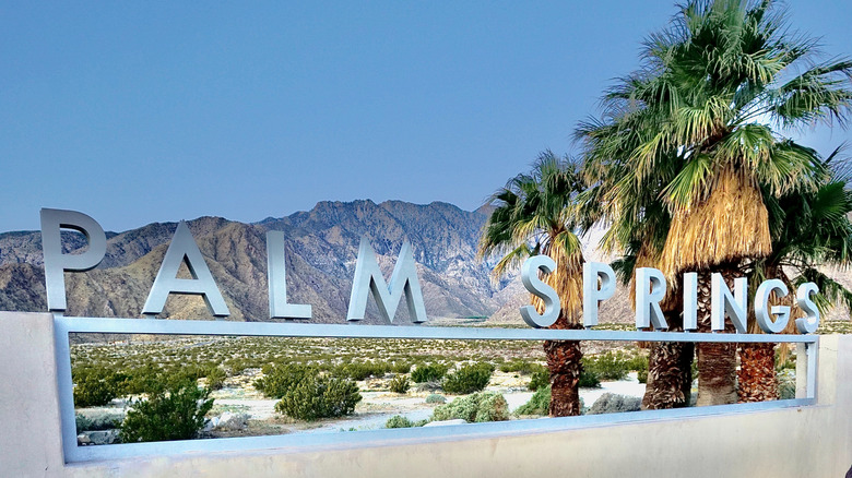 Palm Springs sign in front of desert mountains in California