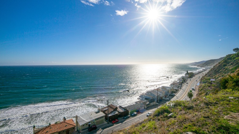 The Pacific Coast Highway winds along the California Coast next to oceanfront mansions in Malibu, California.