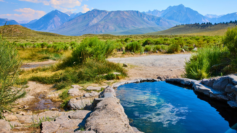 Rock pool hot springs overlooking mountains