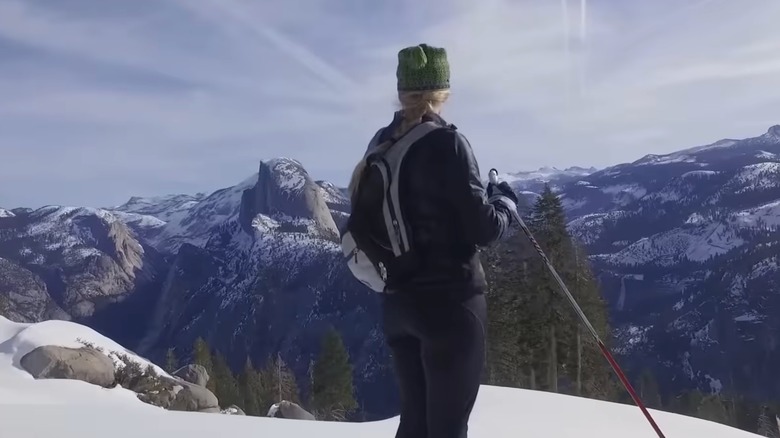 Cross country skier at Glacier Point with Half Dome in the background