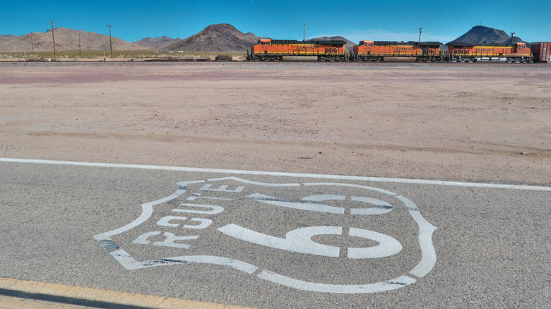 Route 66 road sign with railroad in Goffs, California