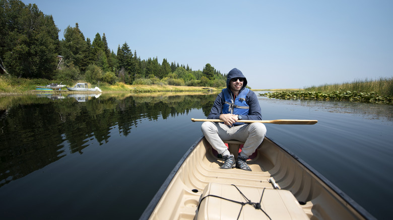 Young man enjoying canoe tour along Klamath River