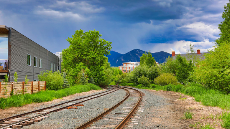 Railroad tracks leading towards the Rocky Mountains in Montana