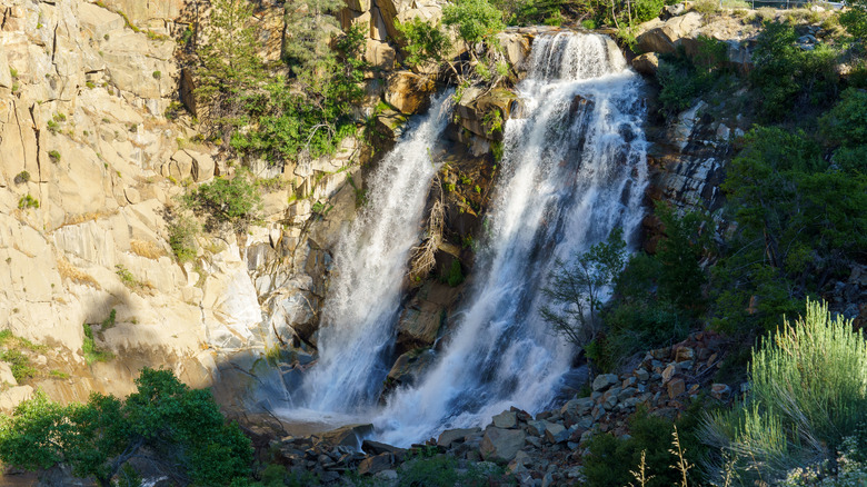 A waterfall flows by Kern River in California