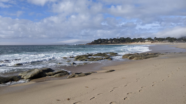 Patches of rock in the sand along Carmel Meadows Beach