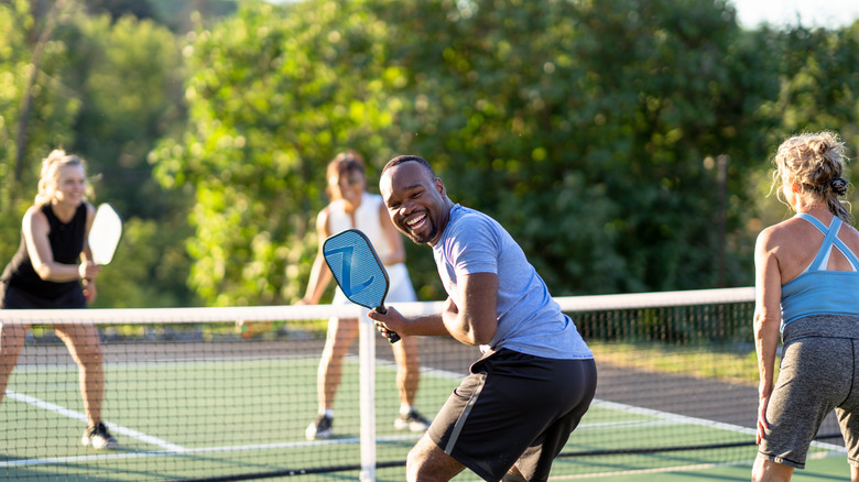 A group of four people playing pickleball