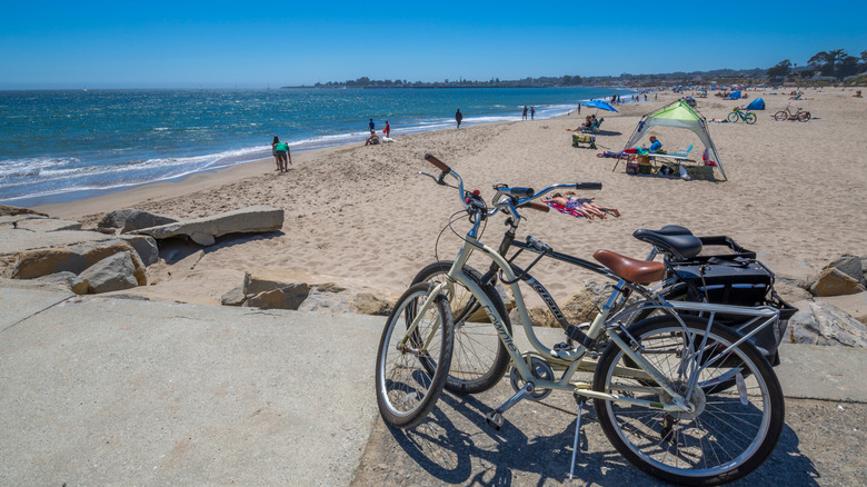 People, parked bicycles, and a tent on Seabright State Beach in Santa Cruz, California