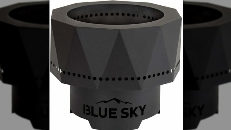 Blue Sky Living Outdoor Fire Pit on white background with flames burning