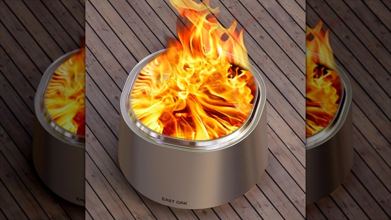 East Oak Camber Fire Pit burning on a wooden deck