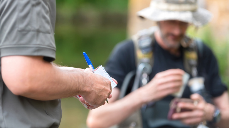 A man checking a camper's papers