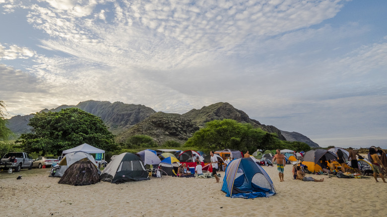 A group of tents and campers on a beach