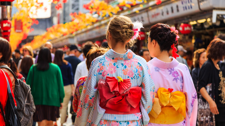 Tourists wear kimonos while walking at the Sensoji temple in Tokyo, Japan
