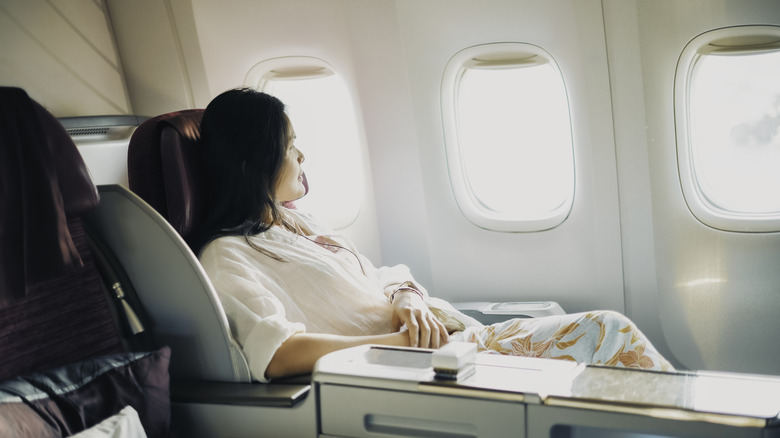 A passenger relaxing in a fancy airplane seat