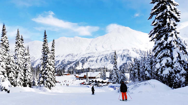 skiers at Powder King Ski Resort, with looming snowy mountains in the background