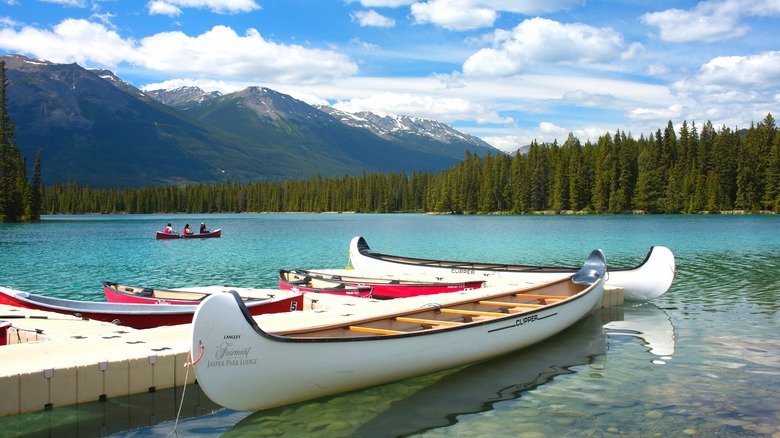 Canoes on the clear water of Lac Beauvert in Jasper National Park Canada