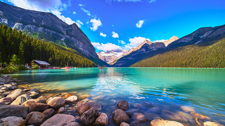 Rocky shore of turquoise Lake Louise in Banff National Park Canada