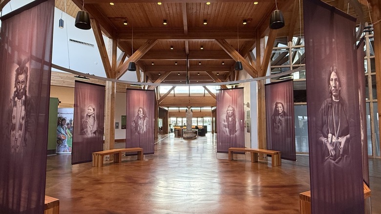 Interior rotunda with displays of Indigenous people and benches in Wanuskewin Heritage Park