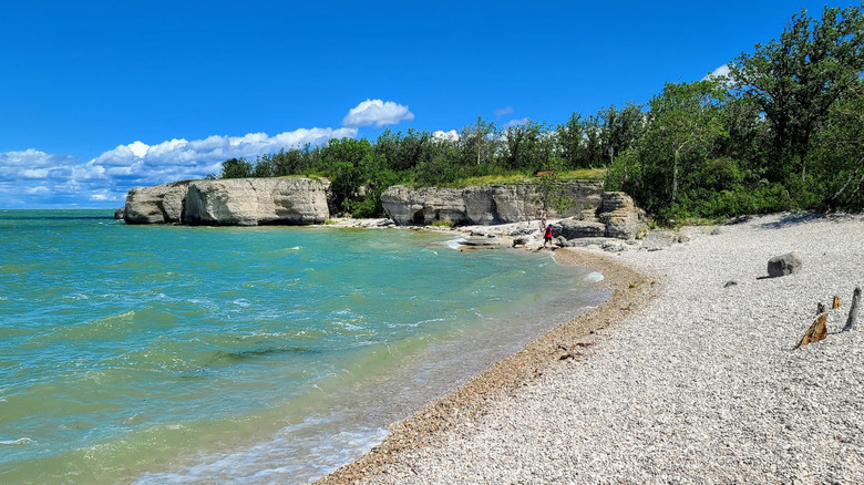 Limestone cliffs and turquoise water at Steep Rock Beach in Manitoba