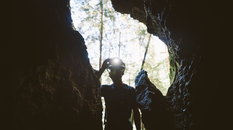 Man standing at a cave opening at Horne Lake Caves Park