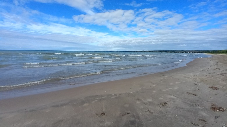 Looking down the sandy shore of a Brighton beach
