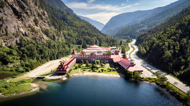 Red roofs and towers of Three Valley lake Chateau, surrounded by forest and mountains